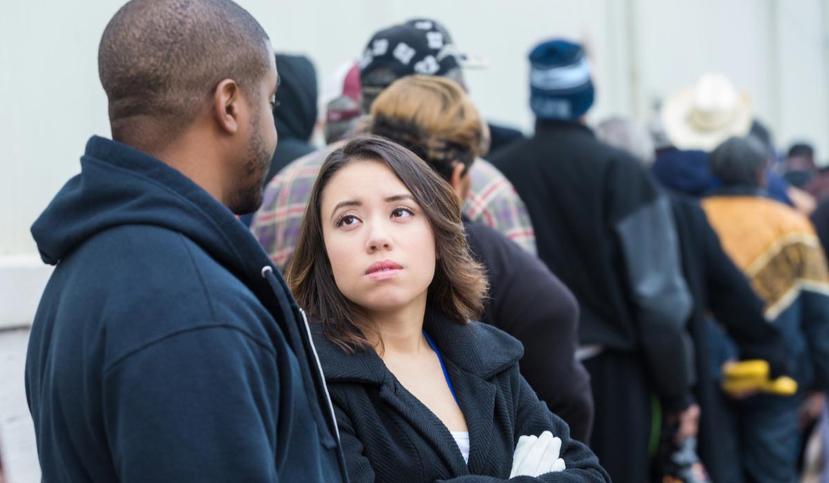 displeased people waiting in line