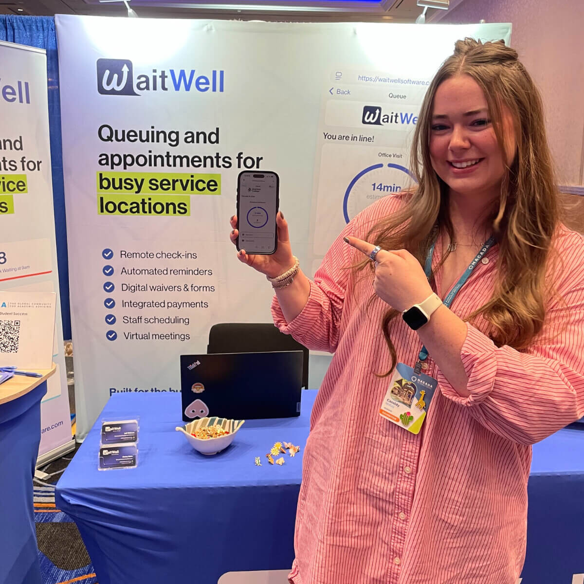 WaitWell conference with Cassidy holding a phone with the mobile view of WaitWell