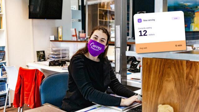 young female receptionist at a clinic facing forward with a screenshot of queue ticket on the top right corner of image